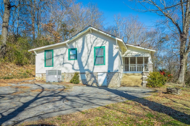 exterior space with central AC and a sunroom