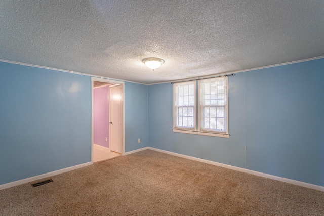 carpeted spare room with a textured ceiling