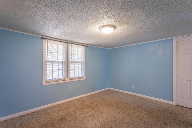 spare room featuring carpet floors, a textured ceiling, and crown molding