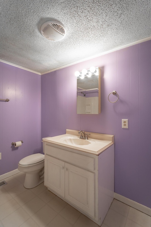 bathroom with toilet, tile patterned floors, wood walls, and vanity