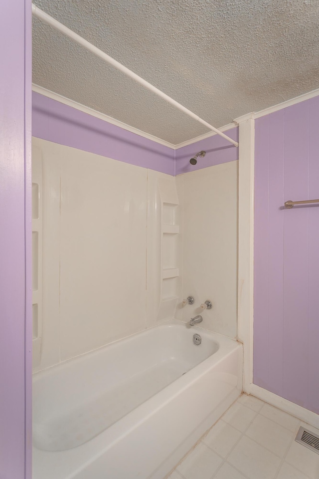 bathroom with tile patterned floors and bathing tub / shower combination