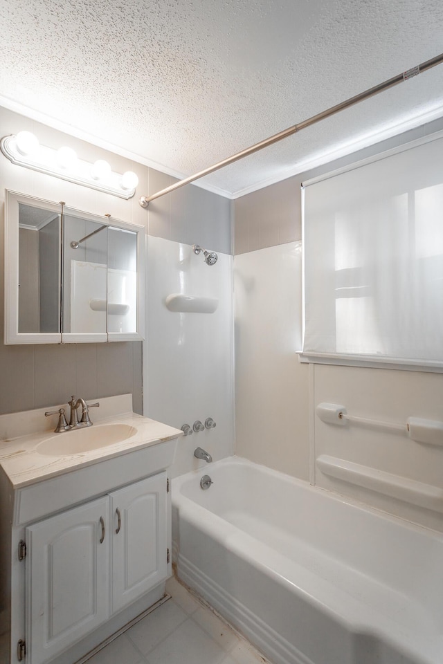 bathroom featuring tile patterned floors, washtub / shower combination, vanity, and a textured ceiling