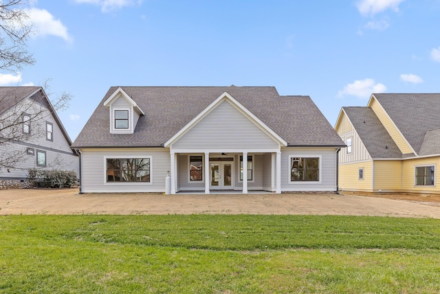 rear view of property featuring a yard and french doors