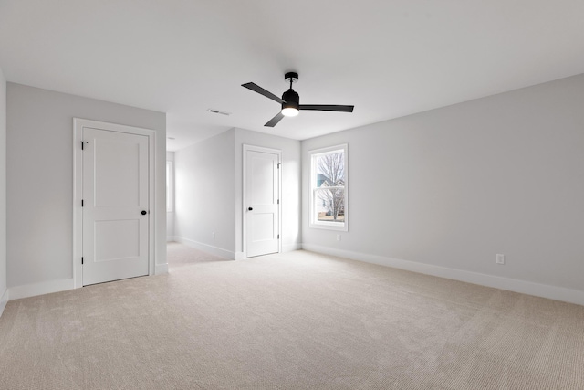 unfurnished bedroom with ceiling fan and light colored carpet