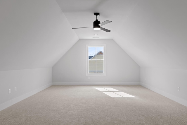 bonus room with ceiling fan, lofted ceiling, and light carpet