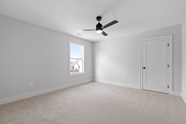 unfurnished room featuring ceiling fan and light carpet