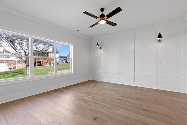 unfurnished room featuring ceiling fan, ornamental molding, and hardwood / wood-style flooring