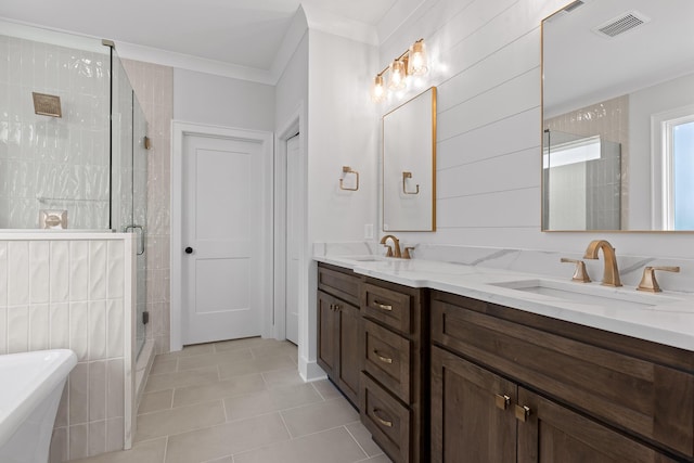 bathroom featuring tile patterned floors, vanity, crown molding, and shower with separate bathtub