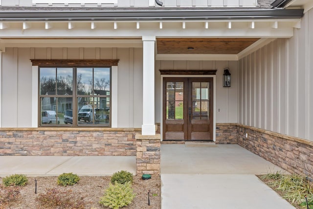 property entrance featuring covered porch and french doors