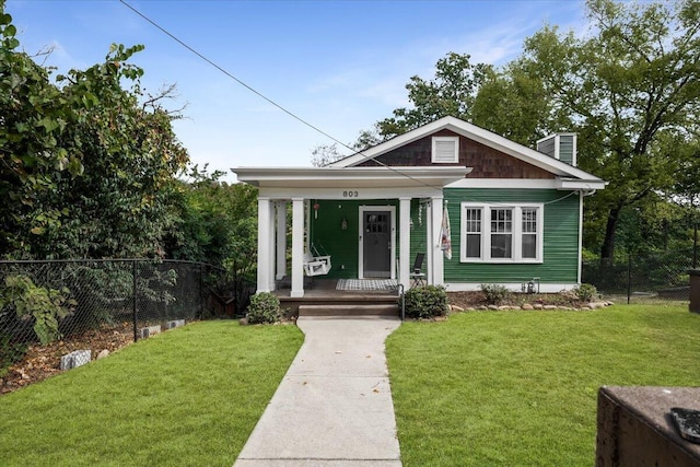 view of front of home with covered porch and a front yard