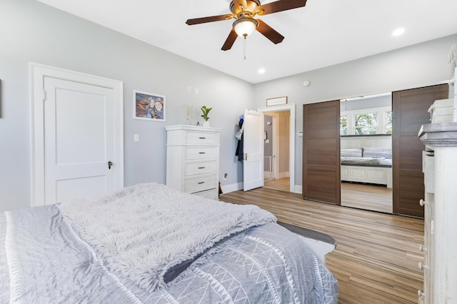 bedroom with ceiling fan and light wood-type flooring