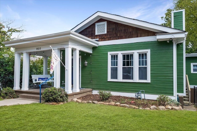 exterior space featuring a front lawn and a porch