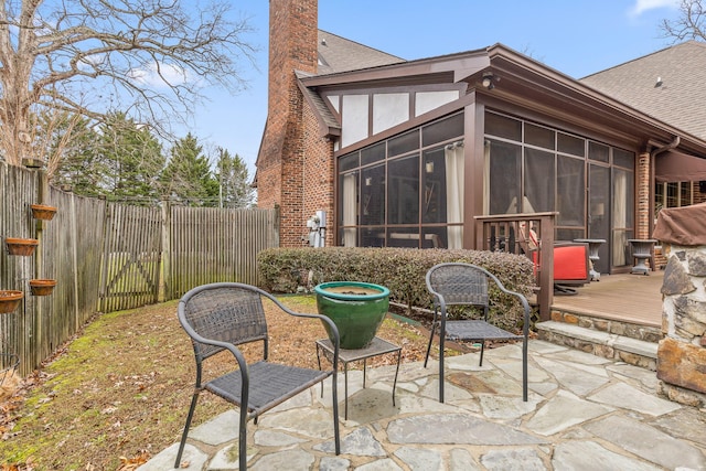 view of patio / terrace with a sunroom and a wooden deck