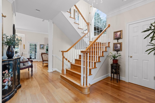 foyer entrance featuring hardwood / wood-style flooring and ornamental molding