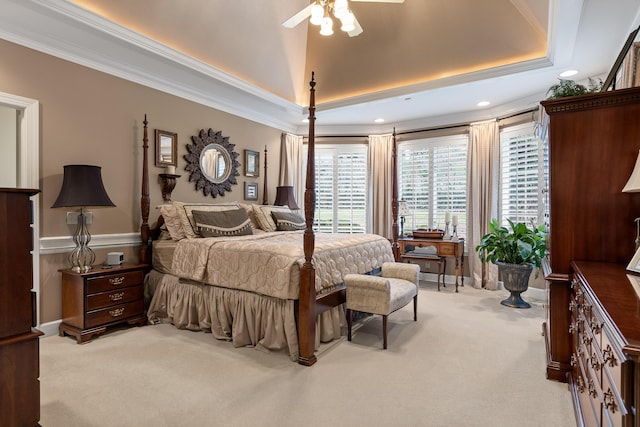 carpeted bedroom with ceiling fan, a raised ceiling, and crown molding