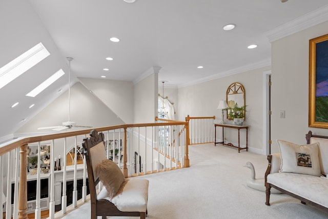 corridor with crown molding, light colored carpet, and lofted ceiling with skylight