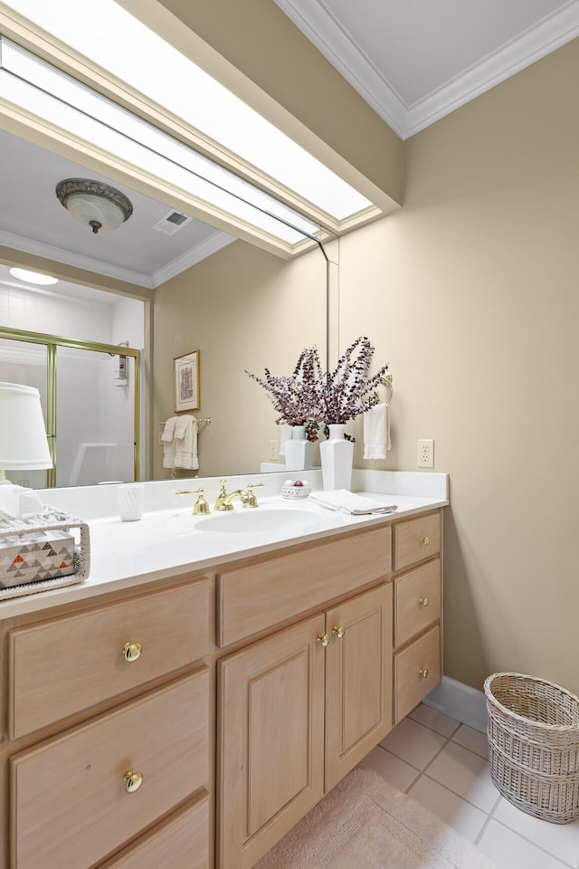 bathroom featuring tile patterned flooring, vanity, a shower with shower door, and crown molding