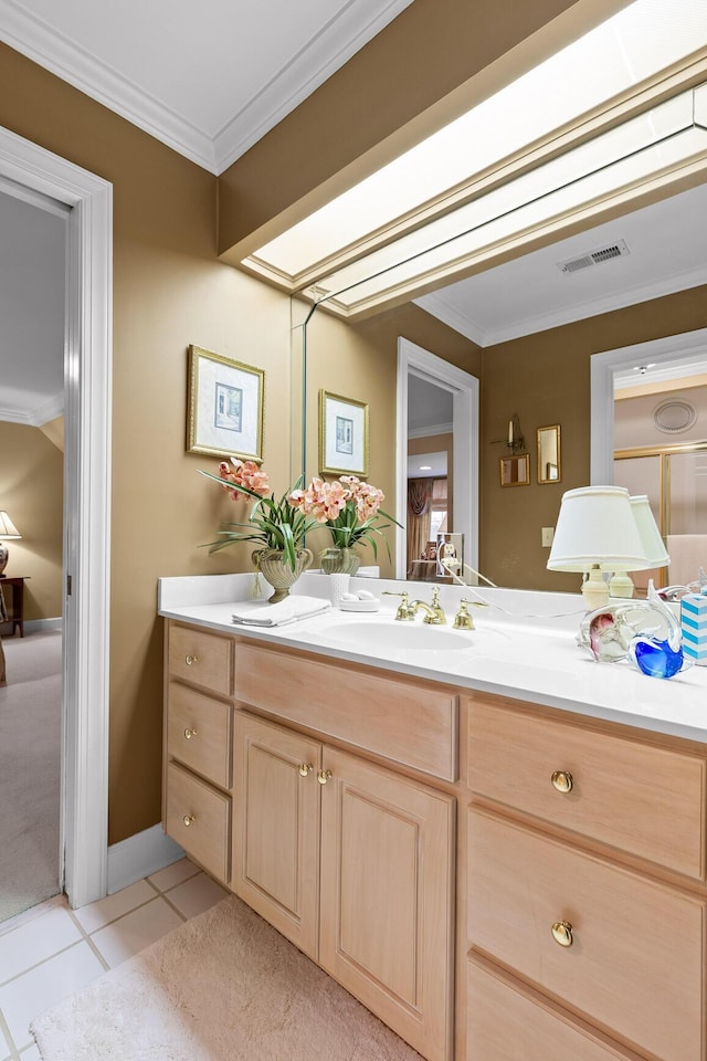 bathroom with tile patterned floors, crown molding, and vanity