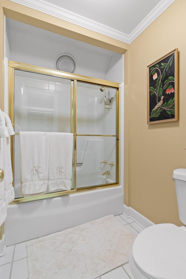 bathroom with tile patterned floors, shower / bath combination with glass door, toilet, and ornamental molding