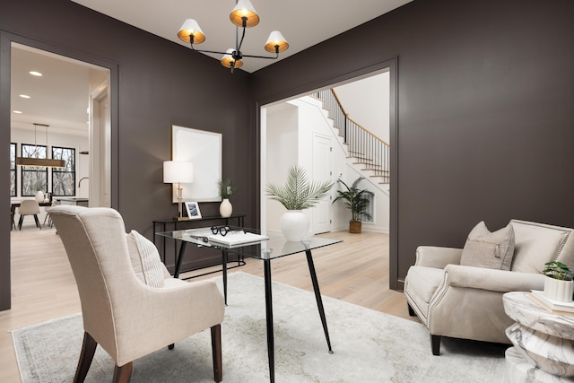 office space with light hardwood / wood-style flooring and a chandelier