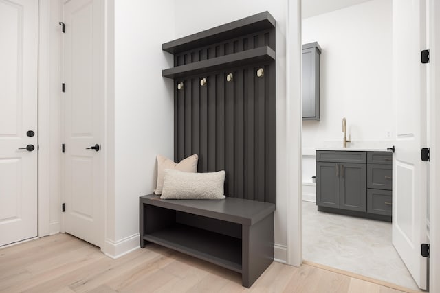 mudroom with light wood-type flooring and sink