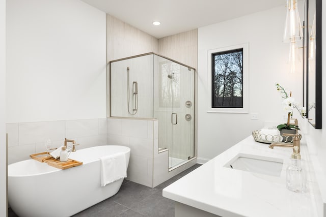 bathroom with vanity and independent shower and bath