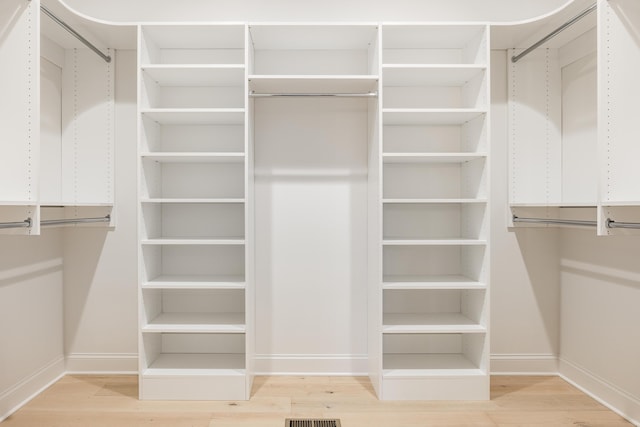 walk in closet featuring hardwood / wood-style flooring