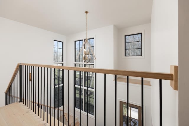 hall featuring plenty of natural light and an inviting chandelier