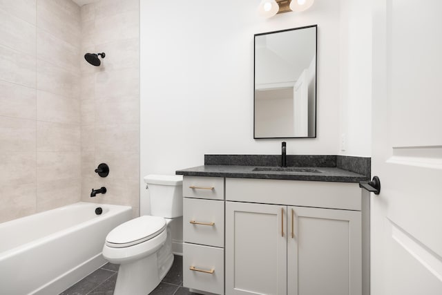 full bathroom featuring tile patterned floors, tiled shower / bath combo, toilet, and vanity