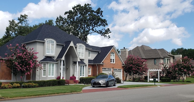 view of front of house featuring a garage and a front lawn