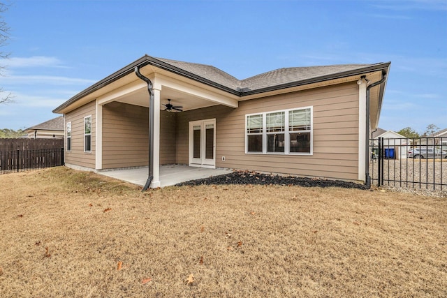 back of house with ceiling fan, a patio area, and a yard