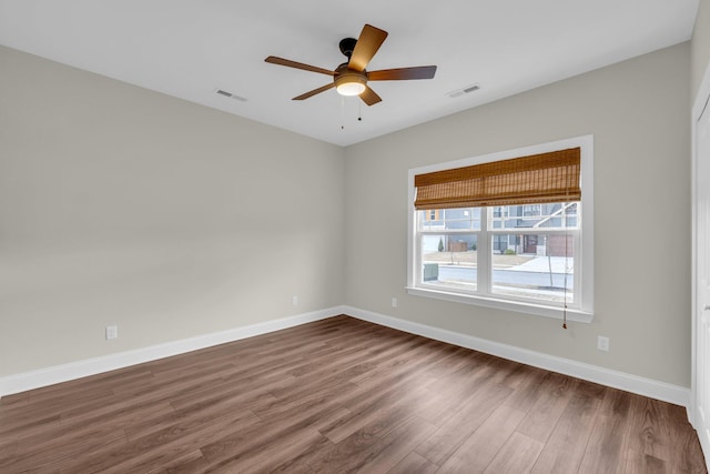 unfurnished room with dark hardwood / wood-style floors and ceiling fan