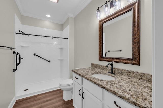 bathroom featuring walk in shower, toilet, hardwood / wood-style flooring, vanity, and ornamental molding