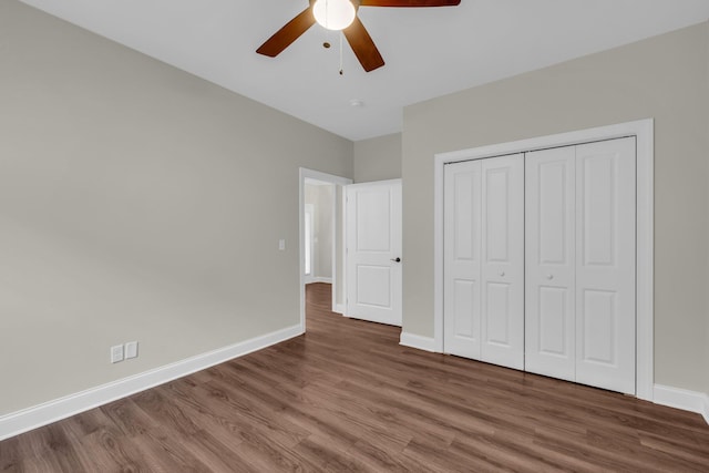 unfurnished bedroom with ceiling fan, a closet, and dark hardwood / wood-style floors