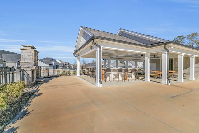 view of property's community with a patio and an outdoor bar