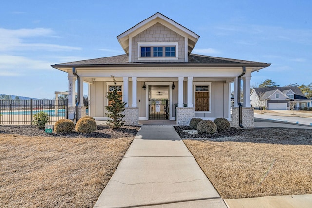 view of front of home with a swimming pool