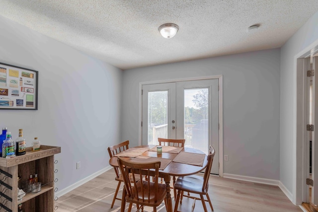 dining area featuring french doors and a textured ceiling