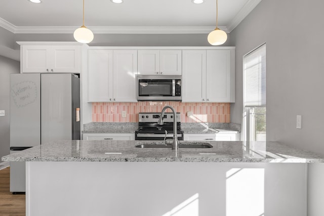 kitchen featuring decorative backsplash, white cabinetry, stainless steel appliances, and hanging light fixtures