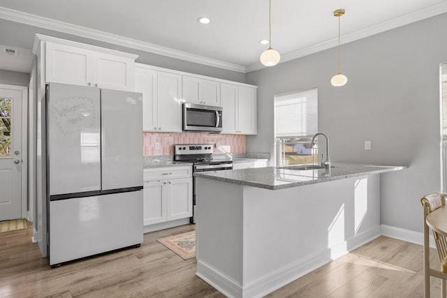 kitchen with appliances with stainless steel finishes, tasteful backsplash, and white cabinetry