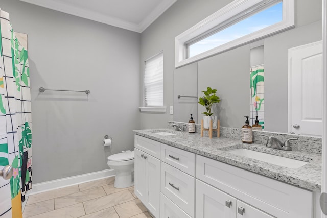 bathroom with vanity, toilet, and ornamental molding