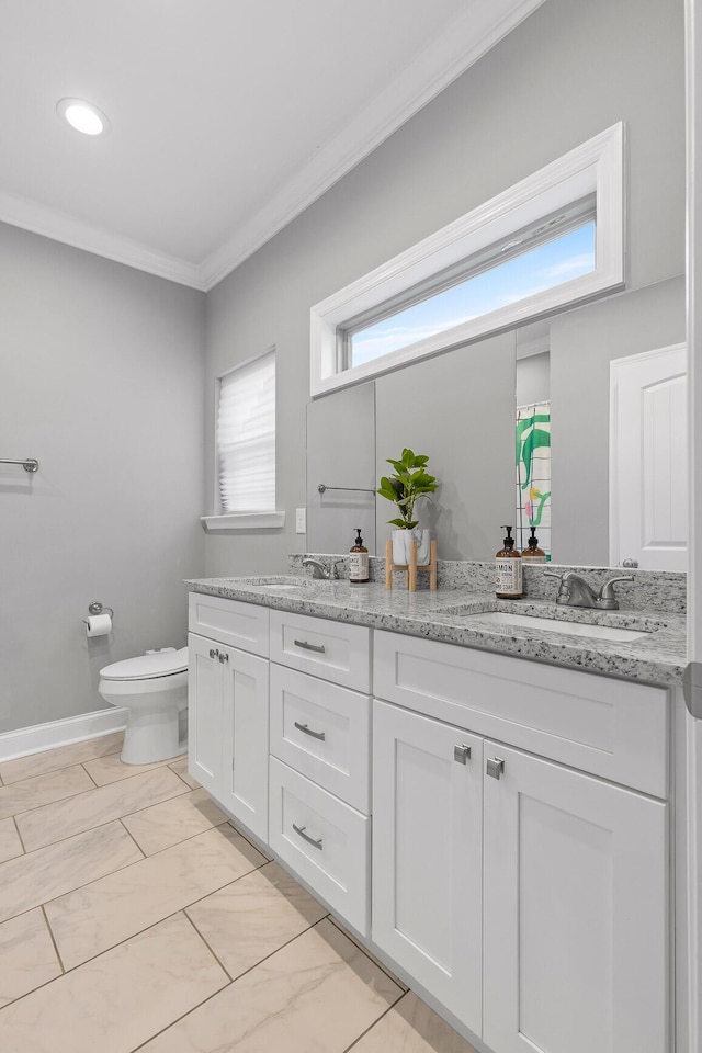 bathroom with vanity, ornamental molding, and toilet