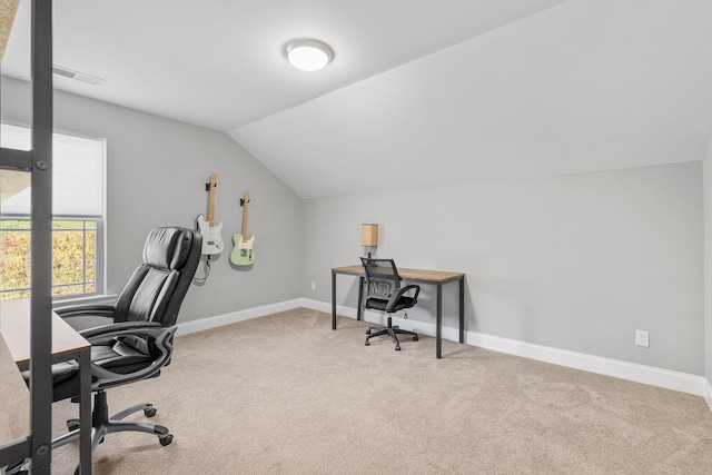 carpeted office space with vaulted ceiling