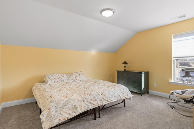 carpeted bedroom with vaulted ceiling