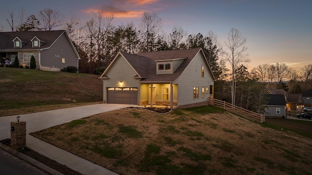 view of front of home with a yard and a garage