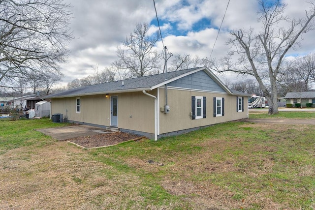 back of house featuring a patio, cooling unit, and a lawn