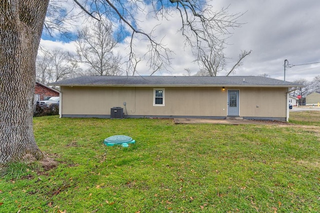 rear view of house featuring a lawn