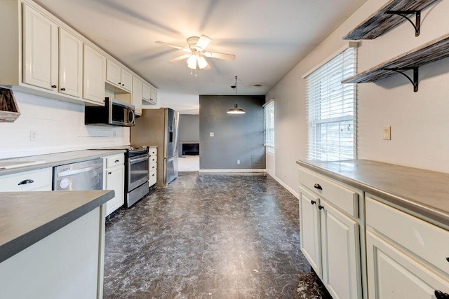 kitchen with white cabinets, decorative light fixtures, ceiling fan, and appliances with stainless steel finishes