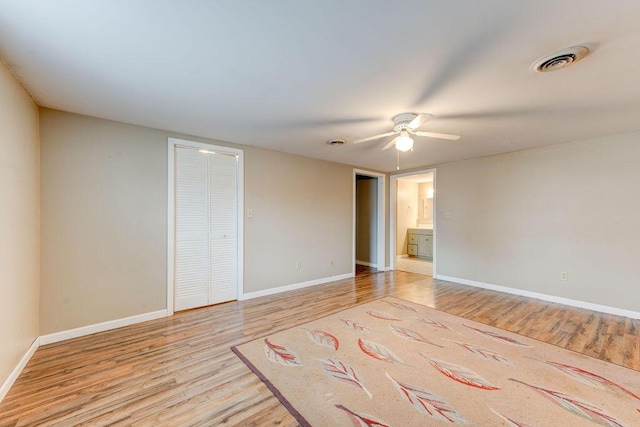 spare room featuring ceiling fan and light hardwood / wood-style floors