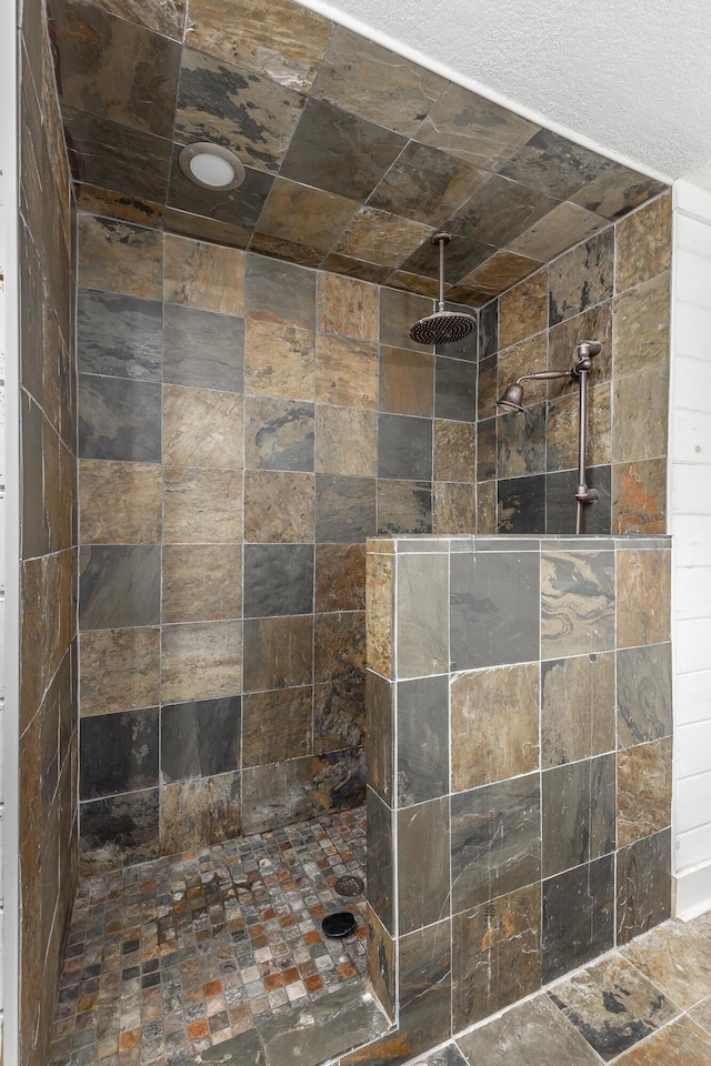 bathroom with a tile shower