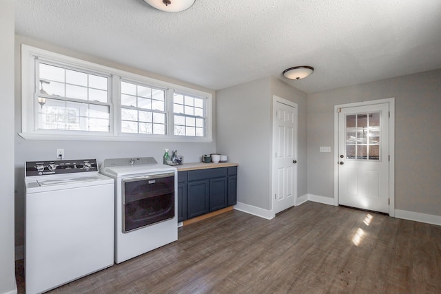 washroom with washer and dryer, cabinets, a textured ceiling, and dark hardwood / wood-style flooring